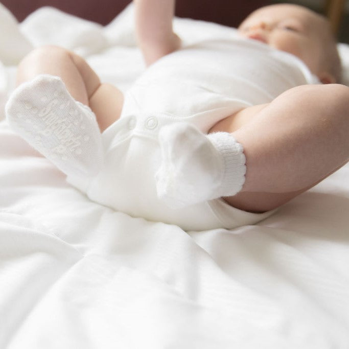 Snugabugz white organic cotton Baby Socks That Stay On Baby's Feet gender neutral infant socks with non-slip soles. Pack of 3 pairs of newborn socks. Baby socks that don't fall off. Baby socks with grips