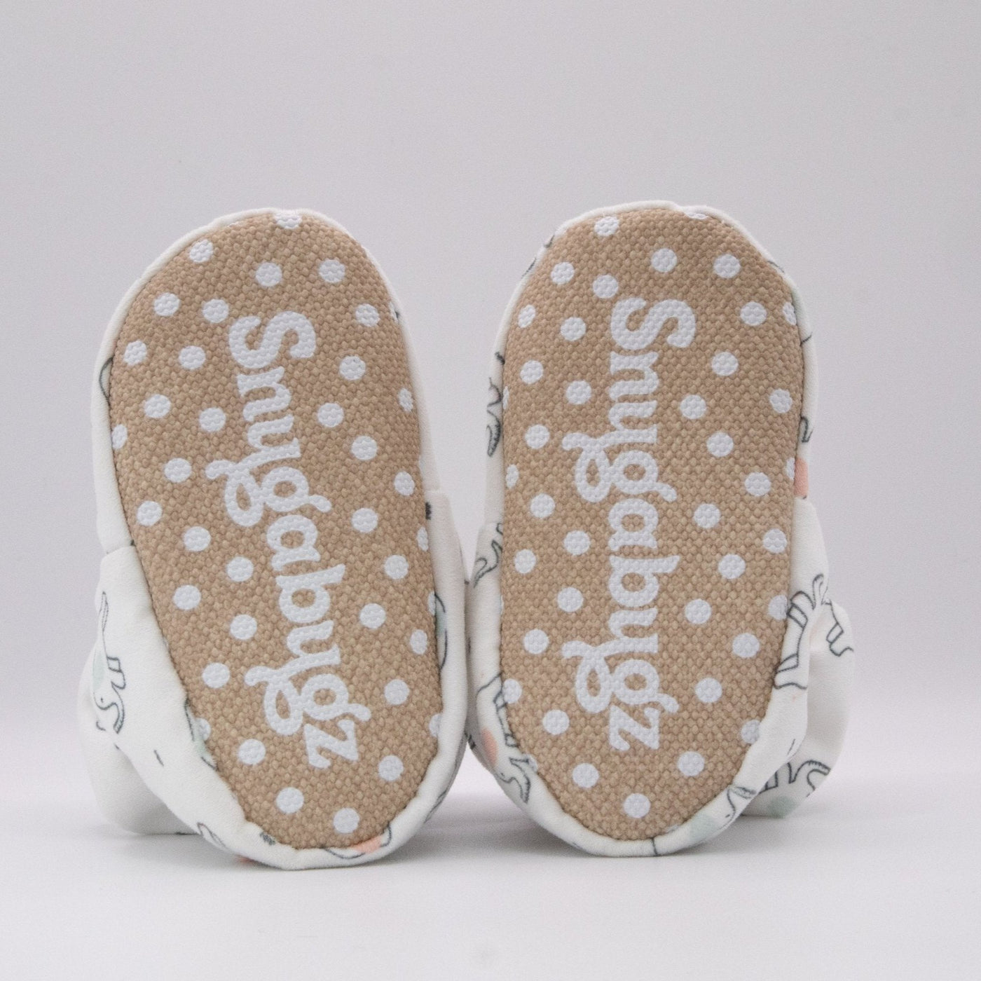 Gender Neutral white baby booties that stay on for infants made with soft organic cotton, sustainable, with flexible non-slip soles. Barefoot soft sole baby shoes. unique baby shower gift idea or new baby gift idea. Cute Unisex Elephant Print