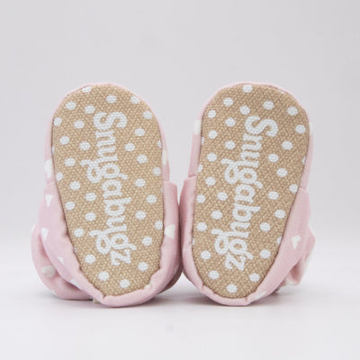 Snugabugz pink baby girl booties that stay on for infants made with soft organic cotton, Vegan, sustainable, with flexible non-slip soles. Barefoot soft sole baby shoes in gift box for baby shower gift or new baby girl gift idea.