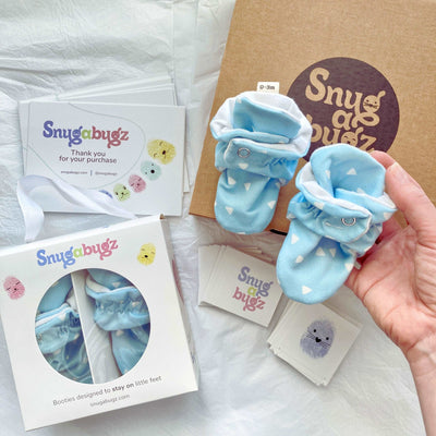 Snugabugz blue newborn baby boy booties that stay on with non-slip soles in gift box for original baby shower gift or new baby boy gift idea