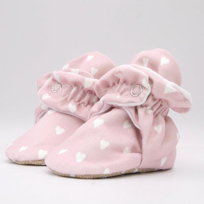 Pink baby girl booties that stay on for infants made with soft organic cotton, sustainable, with flexible non-slip soles. Barefoot soft sole baby shoes. Barefoot soft sole baby shoes in gift box for baby shower gift or new baby girl gift idea.